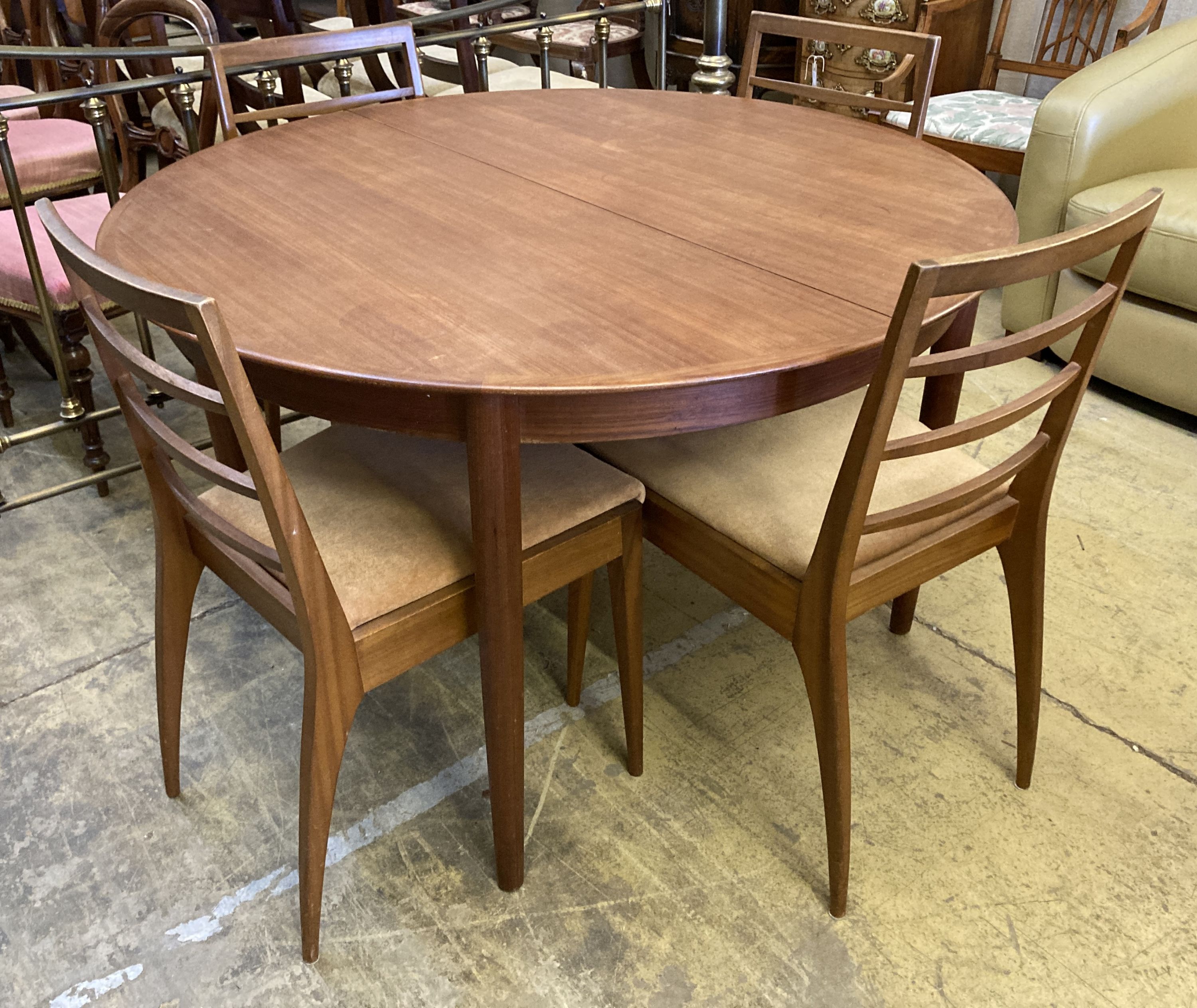A mid century design Dryland Danish teak extending dining table, 120cm diameter, height 72cm and four chairs